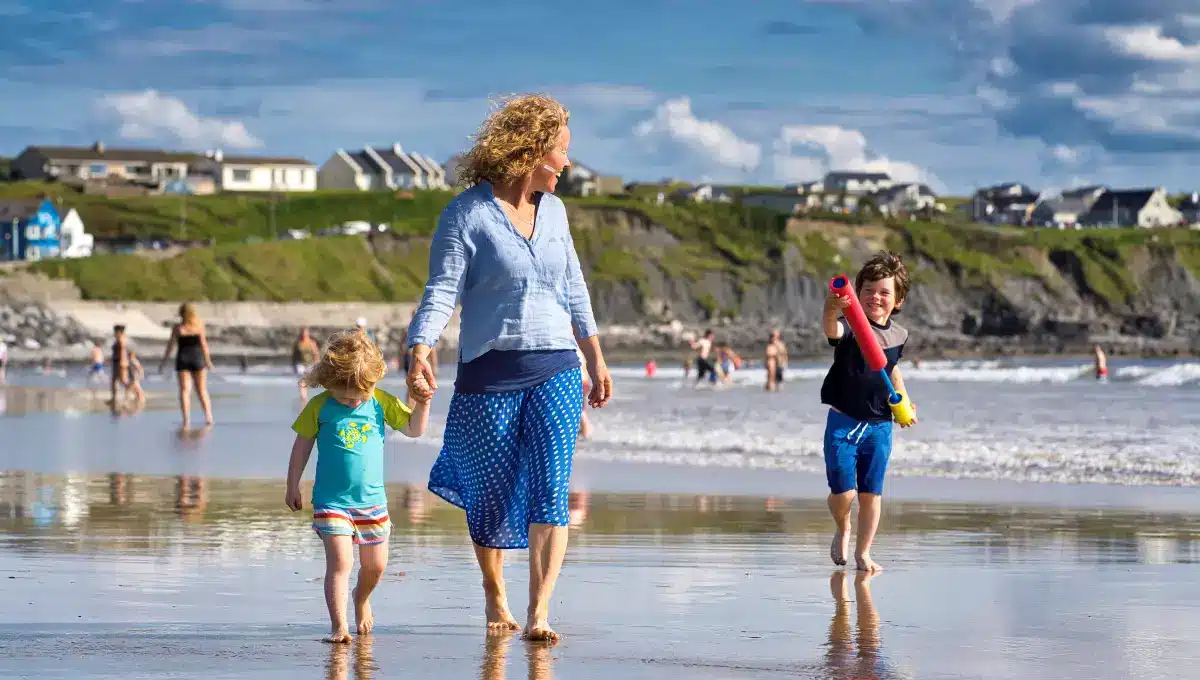 Family walking Lahinch Beach, Co Clare